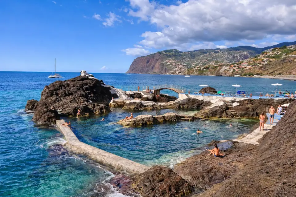 Swimmers in natural rock sea pools on Madeira’s south coast