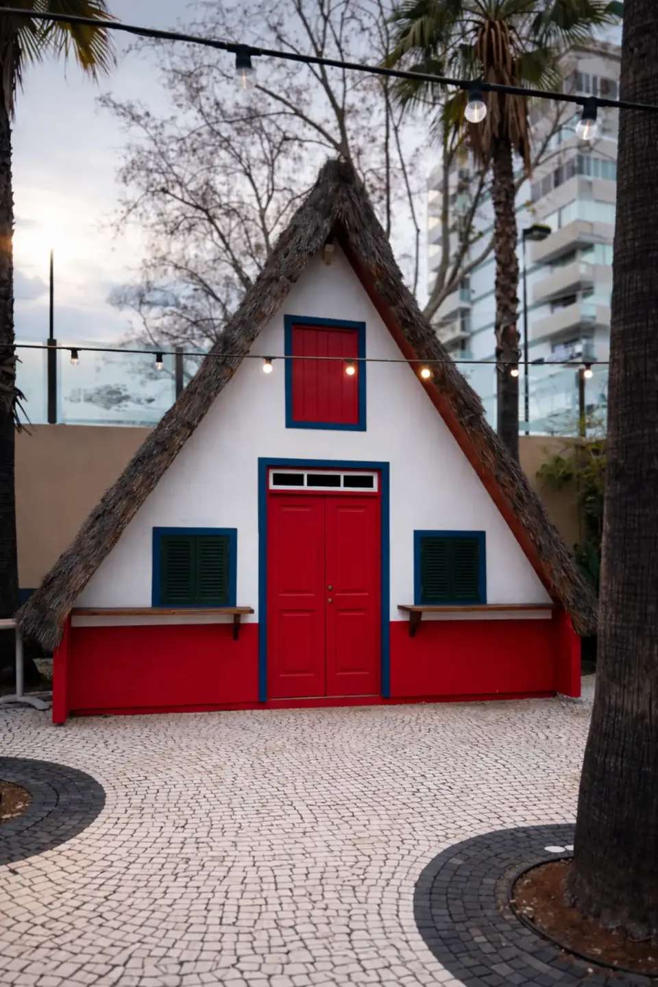 Traditional Madeiran A-frame house with thatched roof and red door